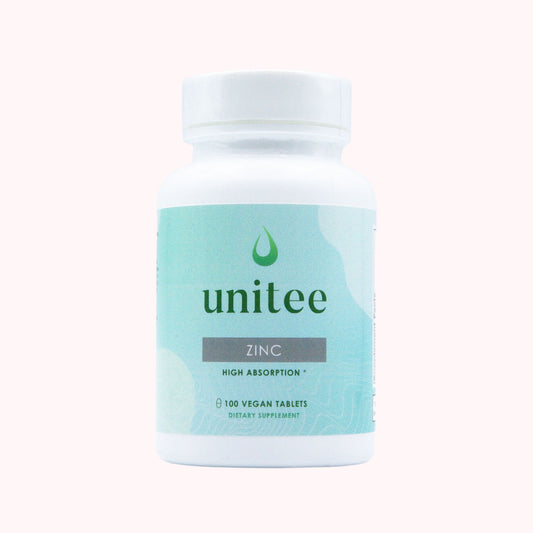 A bottle of Unitee brand zinc supplement with high absorption, containing 180 vegan tablets, in a white and green label.